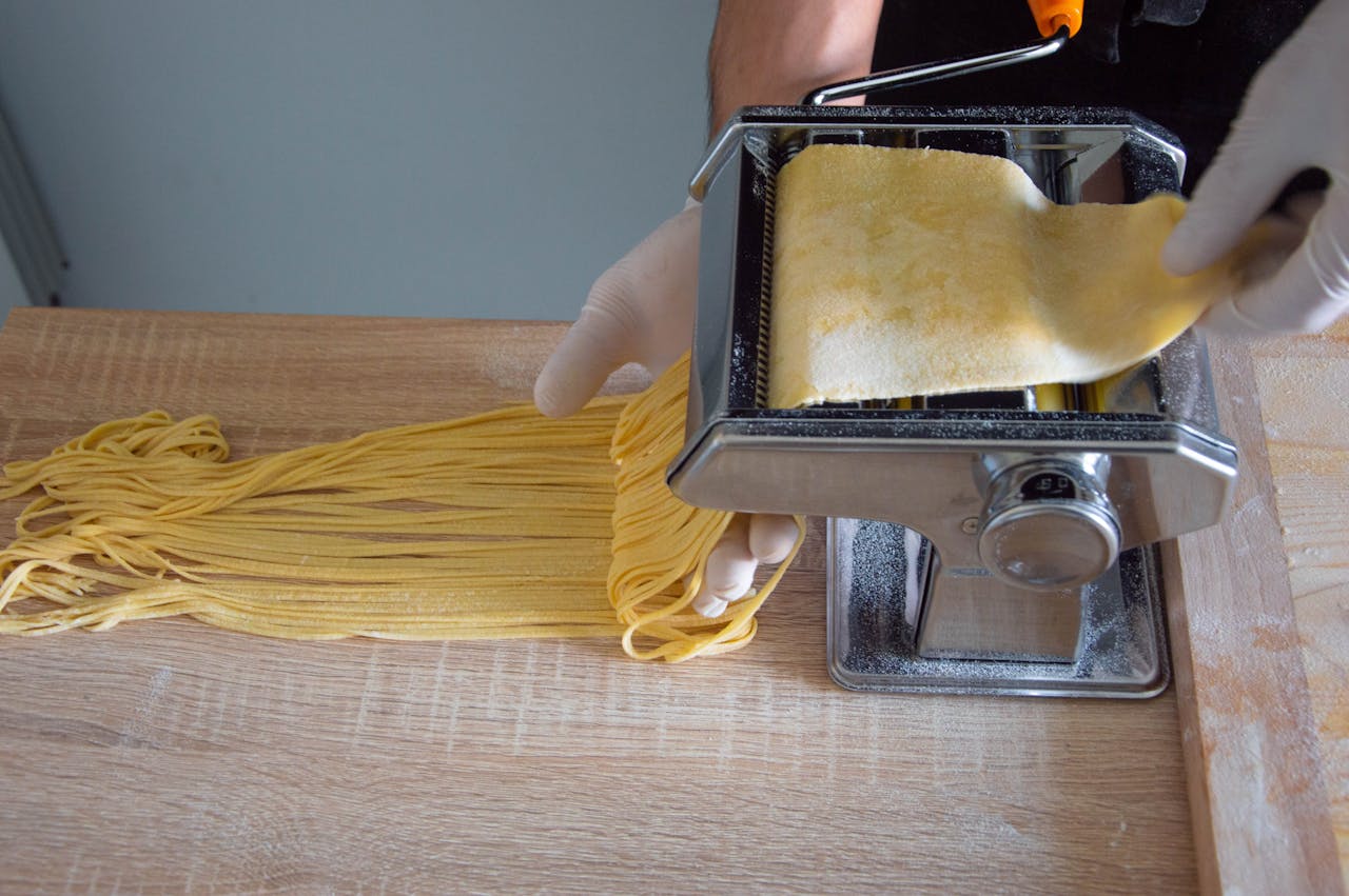 Close-up of pasta maker creating fresh spaghetti in a Roman kitchen.