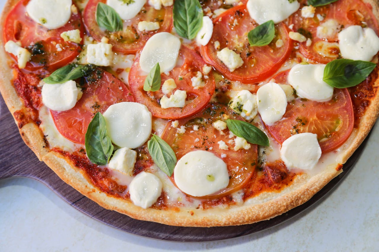 Delicious homemade Margherita pizza topped with fresh basil and mozzarella cheese.